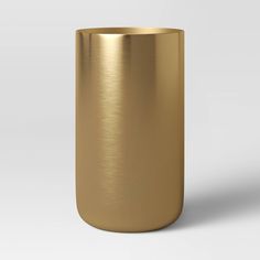 a gold colored metal cup on a white background