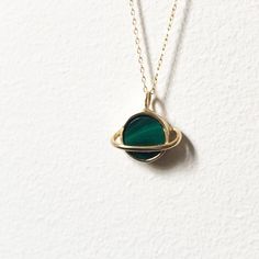 This sweet pendant is made using a saturn setting that I handmade and had cast in brass, which is then plated in shiny 14k gold. A beautiful  banded green malachite is set in the center, and it hangs on an 18" 14k gold-filled chain. Perfect for that space loving gal. Also available with a lapis, abalone, opal/turquoise/copper mash up, moonstone, or turquoise. Recycled Gold Gemstone Jewelry For May Birthstone, Brass Pendant Jewelry With Polished Finish, Nickel-free 14k Gold Filled Pendant Jewelry, Round Brass Birthstone Jewelry, Brass Round Pendant Birthstone Jewelry, Brass Birthstone Round Pendant Jewelry, Brass Birthstone Jewelry With Round Pendant, Polished Round Emerald Jewelry, Unique Yellow Gold Jewelry For May Birthstone