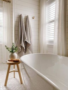 a white bath tub sitting next to a window