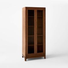 a wooden bookcase with glass doors on the front and bottom shelves, against a white background