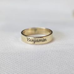 About item Item :- Custom Band engraved ring Ring size :- Chose from variation (Custom size accepted) Material  :- 925 Sterling silver Purity  :- 92.5 Title:- Personalized Word Ring, Custom Name Ring, Dainty Name Ring, Personalized Stacking Ring Gift, Unisex Ring, Unique Anniversary Gift for Her, Valentine's day gift, Promise ring, Couple rings, Girlfriend ring, Delicate ring Description:- We use 925 sterling silver to making jewelry. We accept all types of custom & personalized order. Please send us a message if you are interested in a custom creation. Shipping profile:- We ship all order within 3-5 days. But custom order takes time. Customer service :- If you have any question about our products & services, feel free to contact us. We do always best for our customers Other Specification: Initial Ring Gold Personalized, Adjustable Engraved Ring With Text For Promise, Hand Stamped Yellow Gold Engraved Ring For Anniversary, Anniversary Yellow Gold Hand Stamped Engraved Ring, Gold Engraved Promise Ring With Hand Stamped Details, Gold Engraved Hand Stamped Promise Ring, Gold Hand Stamped Engraved Promise Ring, Gold Hand-stamped Engraved Promise Ring, Adjustable Engraved Gold Rings