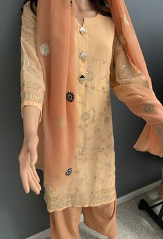 Elevate your style in this book peach  color embroidered kurti with mirror buttons. The kurti has palazzo pants and embroidery dupatta to give it a perfect style. Kurti With Pants, Embroidery Dupatta, Indian Kurti, Embroidered Kurti, Embroidered Dupatta, Peach Color, Palazzo Pants, Womens Clothing Tops, Cold Shoulder Dress