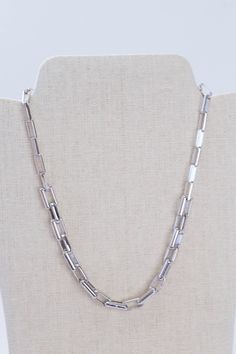 This Rhodium Link Necklace is crafted from silver and features 14" of chain with a secure Claw Clasp Closure for added security. It's the perfect accessory for any occasion. General Info: Fashion jewelry 14" Claw Clasp Closure Imported Silver Link Jewelry, White Gold Metal Box Chain Necklace, Silver Chain Link Metal Jewelry, Metal Link Jewelry With Silver Chain, Silver Chain Link Jewelry, Silver Stainless Steel Necklace With Box Chain, Stainless Steel Silver Necklace With Box Chain, Silver Link Jewelry With Box Chain, Silver Link Jewelry With Adjustable Chain