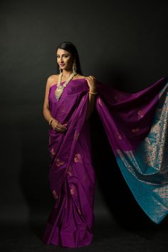 Get ready to turn heads with this stunning silk saree! The beautiful purple and azure blue color combination of this Silk saree will make a strong statement no matter where you go. Intricate gold embroidery work along the pallu adds a bit of traditional flair that makes this saree perfect for special occasions. Whether you're attending a wedding or hitting up an office party, this classic yet eye-catching look is sure to make your mark on any setting. Plus, you'll stay comfortable since the lush Elegant Blue Pre-draped Saree For Puja, Bollywood Style Purple Handloom Pre-draped Saree, Traditional Purple Tissue Silk Pre-draped Saree, Purple Katan Silk Pre-draped Saree With Zari Work, Designer Purple Tussar Silk Saree, Purple Katan Silk Pre-draped Saree With Cutdana, Designer Purple Tussar Silk Traditional Wear, Traditional Tissue Silk Wear In Purple, Purple Tissue Silk Saree With Zari Weaving