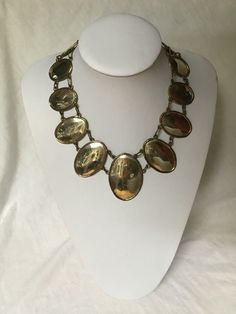 "Free shipping to the USA and Canada. A stunning one of a kind handmade necklace.  This beautiful necklace made from reflective metal, possibly silver would look amazing with any outfit.   Designed with 13 oval silver mirror, with the largest in the centre and then gradually smaller.  The metal reflects just like a mirror. A simple clasp at the top makes for an easy off an on. Measurements: 17\" long 2 1/4\" by 1 1/2\" for the largest of the ovals" Antique Gold Oval Cabochon Necklace, Antique Gold Necklace With Oval Cabochon, Oval Silver Jewelry With Shiny Finish, Elegant Bronze Oval Necklace, Elegant Oval Bronze Necklace, Antique Silver Oval Necklace, Silver Brass Jewelry With Shiny Finish, Oval Metal Necklace For Formal Wear, Oval Metal Necklace For Formal Occasions