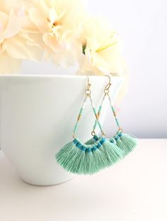 Fringe Earrings,Tassel Earrings,Drop Tassel Earrings,Fan Tassel Earrings,Dangle Earrings,Dangle Tassel Earrings,Boho Earrings,Fan Earrings Mint Color cotton tassels dangle with beads. Ear wires are french hook style in gold plate. These earrings measure 6.5cm (2.5 inches) from top of hoop to bottom of tassels.  Measurement: 6.5cm Length 5.5cm Width Material: Cotton  Please note that earrings are considered intimate items. please check my policy ♥ All pieces come individually packed in gift box Earrings Tassel, Antique Gold Earrings, Fan Earrings, Mint Color, Earrings Drop, Earrings Boho, Fringe Earrings, Circle Earrings, Earrings Dangle