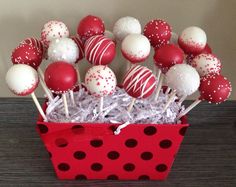 red and white cake pops in a polka dot box