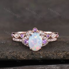 This is a beautiful lab created white fire Opal engagement ring in rose gold. Main Stone: 6x8mm oval cut opal. Side stone: Amethyst + Moissanite. Wedding band: Curved band, Moissanite.. This ring is marked G10K/G14K. I accept custom making order.Please contact me if you need this service. For all the jewelries,there is a 14 days money back guarantee.You can return it in the time frame without any questions.However there maybe handcrafted fee and shipping fee deducted from the original payment as Ruby Engagement Ring Set, White Opal Engagement Ring, Opal Engagement Ring Rose Gold, Fire Opal Engagement Ring, Opal Engagement Ring Set, Cute Engagement Rings, Opal Engagement Ring, Opal Wedding Rings, Opal Engagement