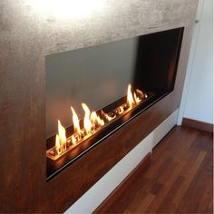 a modern fireplace with flames burning in it