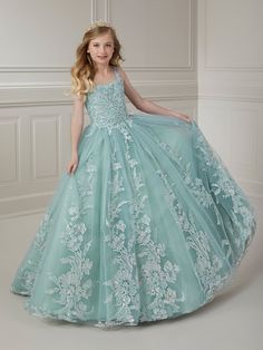 Your sweet girl will make a grand entrance in this beaded floral applique long sleeveless dress with A-line tulle skirt by Tiffany Princess 13720. This sleeveless gown features a scoop neck bodice with beaded floral lace appliques, A-line glitter tulle skirt, sweep train, and a lace-up back. House of Wu Tiffany Princess Collection Fall 2023 Style Number: 13720 Fabric: Beaded Floral Appliques/Tulle Please note: There may be a loss of glitter while wearing this dress due to the nature of the fabri Sleeveless Pageant Dress With Sheer Bodice, Sleeveless Tulle Pageant Dress With Fitted Bodice, Sleeveless Gown With Sheer Bodice For Pageants, Sleeveless Pageant Dress For Prom Season, Sleeveless Pageant Dress With Fitted Bodice, Princess Style Sleeveless Pageant Dress With Fitted Bodice, Sleeveless Pageant Dress With Lace Bodice And Tulle, Sleeveless Tulle Pageant Dress With Lace Bodice, Princess Style Pageant Dress With Sheer Bodice