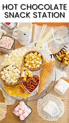 an assortment of desserts on a glass platter with candy and marshmallows