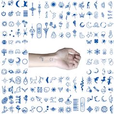 a person's arm with tattoos on it and various symbols in blue ink over white paper