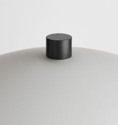 a black object sitting on top of a white table