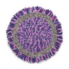 a purple and grey round rug on a white background