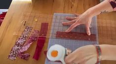 a woman is cutting fabric with scissors and an egg