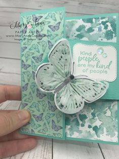 a hand holding up a card with a butterfly on it and the words kind people are my kind of people