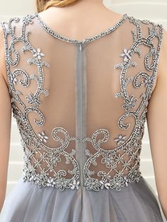 the back of a woman's dress with beading on it