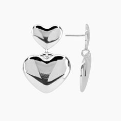 Fall in love with our Mabel Heart Earrings! These stud earrings are coated with rhodium for a stunning finish. Two intertwined hearts add a touch of romance to any outfit. Elevate your style and show your love with these elegant earrings. *Also available in GOLD PRODUCT DETAILS Closure: Post Size: 1" L x 3/4" W Metal: Rhodium Plated Brass Silver Double Heart Earrings, Silver Open Heart Earrings For Party, Modern Earrings For Valentine's Day Anniversary, Modern Heart-shaped Earrings For Anniversary, Modern Earrings For Anniversary On Valentine's Day, Modern Anniversary Earrings For Valentine's Day, Silver Metal Heart Earrings For Anniversary, Modern Silver Heart Earrings For Gifts, Silver Double Heart Earrings For Valentine's Day