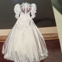 the back of a white wedding dress on display