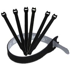 six pairs of black scissors are in a white bowl with a ribbon around the handles