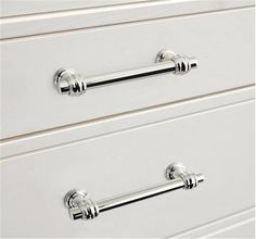 two white drawers with handles on each drawer