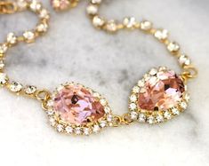 Pink Wedding Bracelets With Sparkling Stones, Pink Crystal Wedding Bracelets, Pink Sparkling Stones Bracelet For Wedding, Pink Cubic Zirconia Crystal Bracelet For Wedding, Elegant Pink Gold Bracelets For Wedding, Elegant Pink Gold Wedding Bracelets, Rose Gold Rhinestone Wedding Bracelets, Rose Gold Crystal Jewelry For Bridesmaids, Adjustable Pink Gold Wedding Bracelets