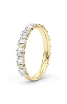 a yellow gold wedding band with baguettes and diamonds on the side, set in 18k yellow gold