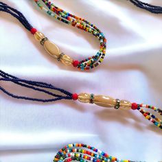 **DRIP FAIRY IS CURRENTLY OPEN FOR PRE-ORDERS ONLY! ALL ORDERS WILL NOT BE SHIPPED OUT UNTIL FEBRUARY 24, 2024. AS A THANK YOU TO THOSE PRE-ORDERING THESE ORDERS WILL ALSO INCLUDE A FREE GIFT! This handmade Ivorian waist bead has an incredibly beautiful four strand design in the colors of purple, gold, and red. Each waist bead is carefully crafted using a combination of strong threads woven together to create a durable and long-lasting piece. The beads themselves are made from glass and each one is carefully chosen to ensure a consistent look and feel to the waist bead. Crafted using high-quality materials, this waist bead is durable and designed to last. The strands provide a comfortable and secure fit, while the adjustable length ensures that it can fit a wide range of waist sizes. The p Bohemian Handmade Beaded Necklaces For Traditional Ceremonies, Multi-strand Beaded Waist Beads For Festival, Bohemian Heishi Beaded Waist Beads, Necklace With Colorful Round Beads For Traditional Ceremonies, Handmade Adjustable Oval Waist Beads, Handmade Bohemian Waist Beads As A Gift, Handmade Bohemian Waist Beads For Gift, Bohemian Multicolor Waist Beads With Gold Beads, Bohemian Handmade Waist Beads As A Gift