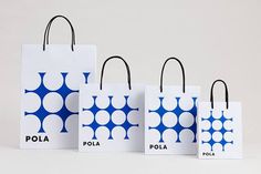 three white bags with blue polka dots on them