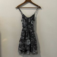 Gray Dress In Great Condition! Features Non Adjustable Straps, Cinched Waist, And Ruffles On Dress. Dress Is Beautiful And Flattering On Everyone! Length (Including Straps): 33.5” Pit To Pit: 15” Waist: 13” (Can Stretch Though) My Poshmark Closet Is A Curated Boutique For Anyone Who Wants To Make A Statement With Their Style. We Offer Brand New, Like New, And Pre-Loved Clothing. On Poshmark, We Offer You Clothes That Will Always Be One Of A Kind - Just For You! Our Prices Are Competitive So Shop Gray Sleeveless Dress With Ruffles, Gray Sleeveless Ruffled Dress, Sleeveless Gray Dress With Ruffles, Casual Silver Spring Dress, Gray Mini Dress With Ruffles, Gray Ruffled Mini Dress, Ruffle Floral Dress, Cinched Waist, Gray Dress