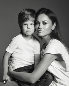 a mother and son are posing for a black and white photo with their arms around each other