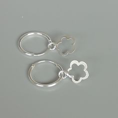 A PAIR of sterling silver hoops. Comes with a detachable cut out flower charm. The charm is multipurpose and can be used with a neck or bracelet chain too. Dimension: Hoop- 15 x 1.5 mm Charm: 10 x 12 mm Drop length- 23 mm These earrings are made of 925 hypoallergenic sterling silver and plastic. Please note this price is for ONE PAIR. All my pieces are sent in a gift box. I can include a personal message from you if needed You are welcome to contact me at... bhavnakwintra1956@gmail.com For more Small Hoop Jewelry With Flower Charm For Everyday, Everyday Small Hoop Jewelry With Flower Charm, Gift Huggie Hoop Earrings With Flower Charm, Nickel Free White Sterling Silver Huggie Earrings, Nickel-free White Sterling Silver Huggie Earrings, Flower Charm Huggie Earrings As Gift, Huggie Jewelry With Flower Charm For Gift, Gift Jewelry Flower Charm Huggie, Hoop Earrings With Flower Charm As Gift