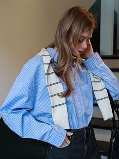 This product is an oversized Eden stripe shirt that effortlessly combines comfort with a relaxed aesthetic. Its exaggerated dimensions bring a contemporary edge to the classic striped shirt. Ideal for casual wear or a laid-back office environment, this piece is a versatile addition to any wardrobe. - This shirt offers a loose, airy fit that doesn't compromise on style, making it a staple for comfort-driven fashion.- Constructed with a durable yet soft fabric, it's designed to withstand regular wear while maintaining its crisp appearance.- Features a classic button-down design with a pointed collar and adjustable cuffs to suit personal style and comfort needs.- The shirt's back yoke is reinforced for added durability, and its hem is slightly longer in the back for a modern, asymmetrica Casual Shirt With Vertical Stripes For Office, Oversized Vertical Stripes Blouse For Work, Striped Relaxed Fit Shirt For Office, Oversized Long Sleeve Shirt With Striped Collar, Oversized Top With Striped Collar For Work, Casual Blouse With Striped Sleeves For Work, Blue Striped Shirt Outfit, Relaxed Aesthetic, Outfit Korean