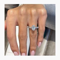 a woman's hand with a diamond ring on it