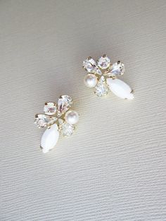 "These fun sparkly earrings are made with fine Swarovski crystals in chalk white and clear crystal mix and Swarovski crystal white pearls. Post earrings with butterfly ear-nuts. Available in gold, silver or rose gold finish. - measurements : 1\" long and 3/4\" wide" White Sparkling Crystal Bridal Earrings, Sparkling White Crystal Bridal Earrings, Glamorous White Cluster Earrings For Formal Occasions, White Crystal Bridal Earrings With Sparkling Stones, White Crystal Embellished Earrings For Anniversary, White Sparkling Cluster Earrings For Formal Occasions, Formal White Sparkling Crystal Earrings, Formal Sparkling White Cluster Earrings, Formal White Sparkling Cluster Earrings