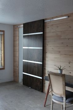 an empty room with wood paneling on the walls