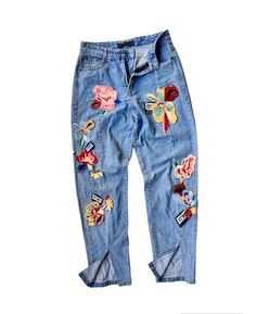 "Description: Elevate your style with these pre-owned vintage jeans featuring delicate flower embroidery and chic patched appliqués, all complemented by a trendy split hem. Each stitch captures the essence of the past, offering a unique blend of nostalgia and contemporary fashion. Embrace sustainable and distinctive style by adding this one-of-a-kind piece to your collection. Details: - Unique patchwork and applique. - Authentic blue jeans crafted from finest materials. - Button-fly and zip-up closure. - Straight leg.  - Split hem.  Size: Waist: 28 - 29\" (Round) Hips: 36\" (Round) Length: 38\" Tight: 22\" (Round) Leg opening: 12\" (Round) Pants / Shirts sizes can vary between brands and regions. So, please have a look at actual measurements above before making the purchase decision. Kindl Spring Floral Embroidered Straight Leg Jeans, Medium Wash Jeans With Patches For Spring, Spring Jeans With Patches In Medium Wash, Spring Medium Wash Jeans With Patches, Spring Straight Leg Jeans With Patches, Spring Denim Bottoms With Patches, Denim Blue Jeans With Patches For Spring, Spring Denim Blue Jeans With Patches, Blue Patched Jeans For Spring