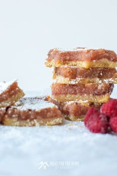 some raspberries and powdered sugar are stacked on top of each other