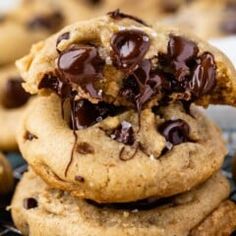 chocolate chip cookies stacked on top of each other with one cookie broken in the middle