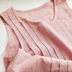 a pink top sitting on top of a white table