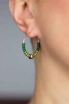 Minimalist hoop earrings with two types of green glass seed beads (shiny and matt), gold tone stainless steel beads and gold tone stainless steel round hoop earrings. Earring hooks are from nickel free and lead free metal. Perfect jewelry for everyday wear or a great gift for someone special! Diameter of hoops is 25 mm. Other earrings of my shop you can see here: https://www.etsy.com/shop/NaTavelli?section_id=13757927 Thanks for visit. Green Beaded Hoop Earrings For Gift, Everyday Green Jewelry With Spacer Beads, Green Dangle Earrings With Spacer Beads, Green Dangle Hoop Earrings With Tiny Beads, Green Hoop Beaded Earrings With Dangling Beads, Green Hoop Beaded Earrings, Green Round Jewelry With Tiny Beads, Green Jewelry With Tiny Beads, Green Earrings With Tiny Beads