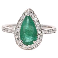 an emerald and diamond ring set in white gold