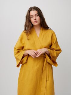 "ATHENA is a robe style linen wrap dress. DETAILS - Self tie belt with no closure or belt loops - Above the the knee length - Robe style - Dropped shoulders - Long sleeves - Side seam pockets - 100% midweight European linen fabric - Cut and sewn to order just for you in our studio COLOR - Mustard, you can also choose other colors above - Fabric samples are available here https://www.etsy.com/listing/586569696/linen-fabric-samples SIZING & FIT - Very oversized fit - Model is 5'6\" / 172 cm and wearing a size M CARE FOR LINEN - Machine wash up to 30ºC/86ºF gentle cycle - Lay flat to dry or tumble dry low - Warm iron if needed - Do not bleach SIZE GUIDE Body measurements guide in inches Size XS to fit bust 30-32\", waist 24-26\" and hips 31-33\" Size S to fit bust 34-36\", waist 28-30\" and h Spring Wrap Robe With Belt, Belted Linen Wrap Dress, Linen Gown, Dress With Kimono, Linen Summer Dress, Linen Wrap Dress, Linen Kimono, Linen Crop Top, Studio Color