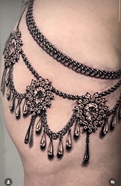 an image of a woman's belly with chains and jewels on the bottom part