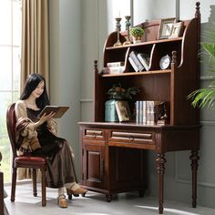 a woman sitting in a chair reading a book