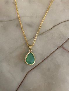 Gold-plated green opal faceted teardrop jewel necklace. The green opal teardrop jewel is set in a gold-plated frame measuring 1.3 cm x 1.8 cm. Hung on a gold-plated chain which measures 45.7 cm (18 inches). Comes in a black velvet cushioned box as seen in last photo. Free of charge. INTERNATIONAL BUYERS please choose the tracking option if you would like your order to be tracked. FREE tracking upgrade with 3 items or more purchased. JEWELLERY CARE please don't wear plated jewellery in the shower Green Teardrop Necklace With Adjustable Chain, Green Teardrop Jewelry With Delicate Chain, Green Teardrop Necklace For May Birthstone, Gold Faceted Drop Necklace, Gold Teardrop Emerald Necklace, Green Teardrop Faceted Necklace, Green Teardrop Gemstone Drop Necklace, Gold Emerald Drop Necklace For May Birthstone, Gold Drop Emerald Necklace For May Birthstone