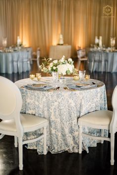 the table is set with white and blue linens for an elegant wedding reception at the grand america hotel