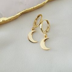 Gold Plated Brass Hoop Earrings with Small Crescent/Half Moon Charm Pendants.  Please note: this listing is for one pair of Crescent Moon Hoop Earrings only. To see the Star Hoop Earrings also pictured click here: https://www.etsy.com/uk/listing/817457714/star-hoop-earrings-gold-plated-brass?ref=shop_home_active_14&frs=1&sca=1 Click here to see more Moon Jewellery: https://www.etsy.com/shop/kazarijewellery/?search_query=moon To return to my shop homepage to see all Jewellery in my Etsy shop clic Moon Jewellery, Star Hoop Earrings, Moon Drop, Brass Hoop Earrings, Brass Hoops, Hoop Earrings Gold, Moon Jewelry, Drop Dangle Earrings, Moon Charm