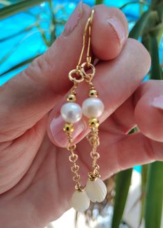 Inspired by traditional Hawaiian leis, this hand made earring set features AAA Natural Freshwater Pearls, gold accent beads, and authentic Natural Mother of Pearl Pikake Beads. The earrings are approximately 3 inches including hook.  These unique beauties are ready for you and your tropical escape. Packaged in a gift box, perfect to give to someone special or to yourself. Complete your beach/resort jewelry with these earrings. These earrings are also  perfect for a beach bride on her special day Delicate Handmade Gold Pearl Earrings, White Jewelry With Latkans For Celebration, Celebration White Jewelry With Latkans, Handmade Delicate Yellow Gold Pearl Earrings, Dainty Handmade Gold Pearl Earrings, Delicate Handmade Yellow Gold Pearl Earrings, Delicate Handmade Jewelry For Celebrations, Bohemian Pearl Charm Jewelry For Wedding, Bohemian Pearl Charm Wedding Jewelry