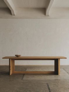 a wooden table sitting on top of a cement floor